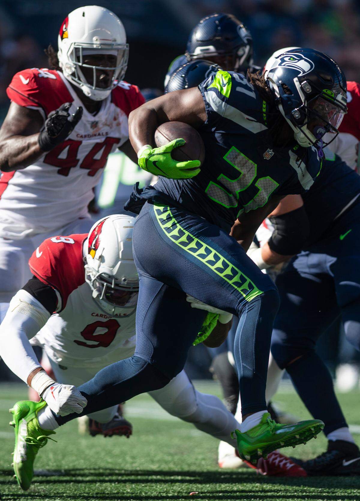 Seattle Seahawks running back DeeJay Dallas (31) runs down the field with the ball after Seattle Seahawks quarterback Geno Smith (7) handed it off to him in the second quarter of an NFL game on Sunday, Oct. 16, 2022, at Lumen Field in Seattle.