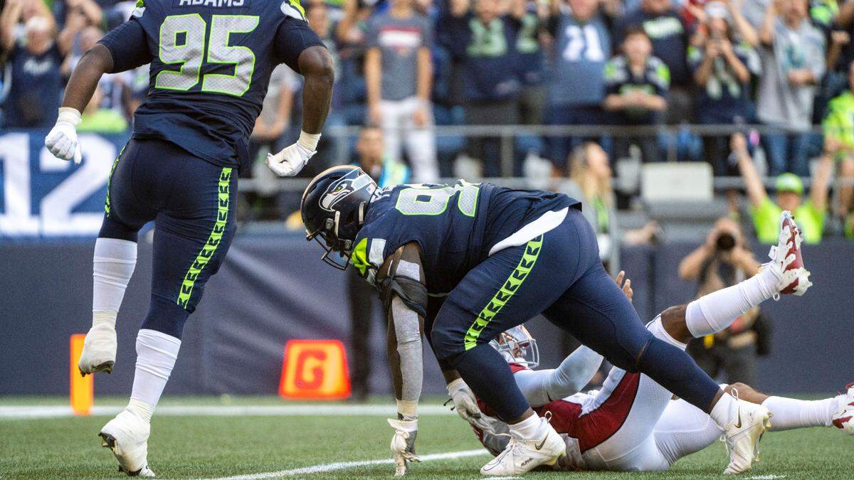 Seattle Seahawks defensive tackle Poona Ford (97) sacks Arizona Cardinals quarterback Kyler Murray (1) during the fourth quarter of an NFL game on Sunday, Oct. 16, 2022, at Lumen Field in Seattle.