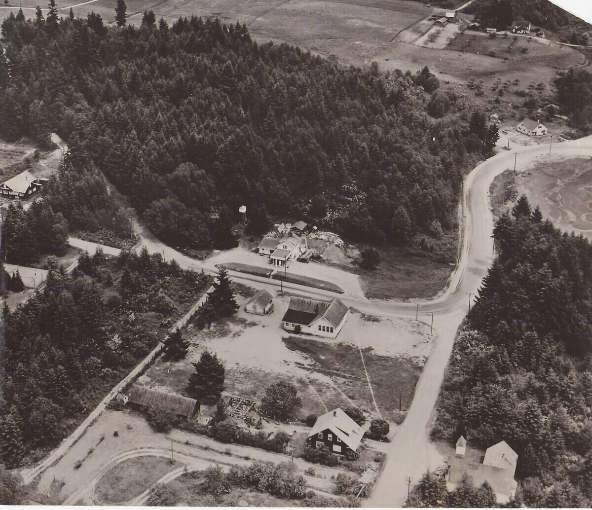 An old photo of Rosedale in an Eide’s Store calendar shows Rosedale Hall in the upper left-hand corner. Jim Langhelm, who was born in Gig Harbor in 1940 and moved into a house (pictured in the upper right corner, next to the road) his father built in Rosedale in 1949, said he estimates the photo was taken in the late 1950s or early 1960s.