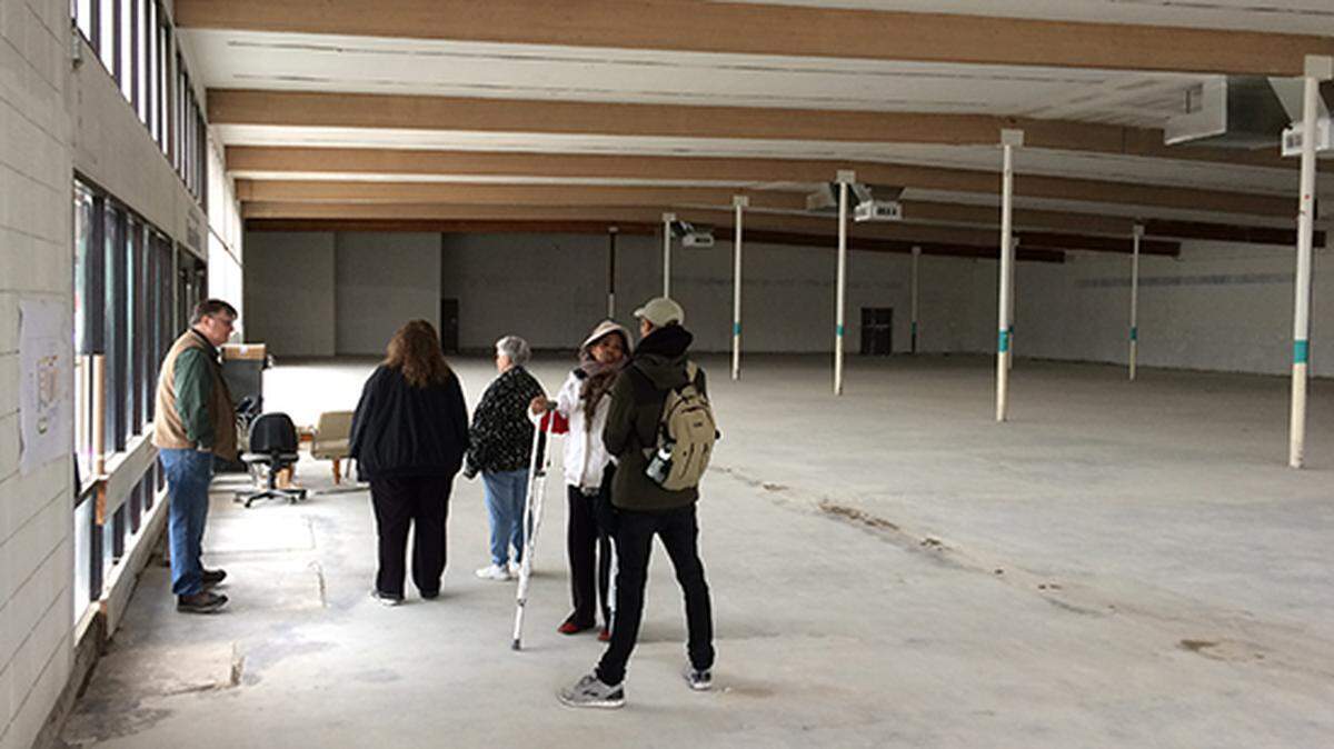 Visitors toured the Pearl Street Central Co-op site earlier this year. The grocery now is not expected to open until next year.