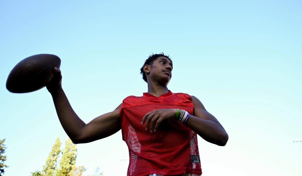 Lincoln quarterback Sione Kaho warms up during practice at Lincoln High School, Friday, Aug. 18, 2023, in Tacoma, Wash.