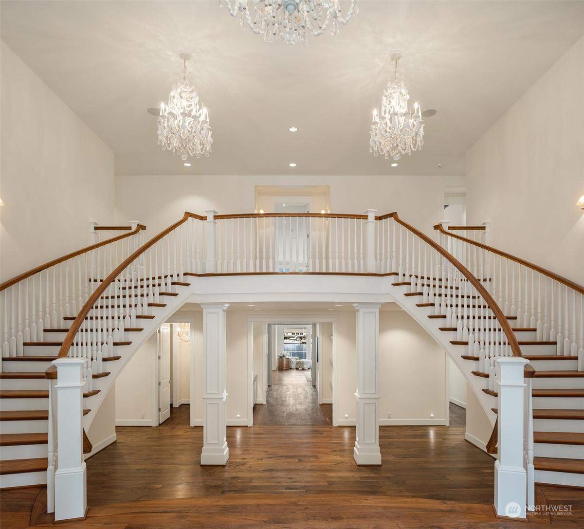 A double staircase greets visitors in the foyer of the home at 7906 Goodman Dr. NW in Gig Harbor, Wash.