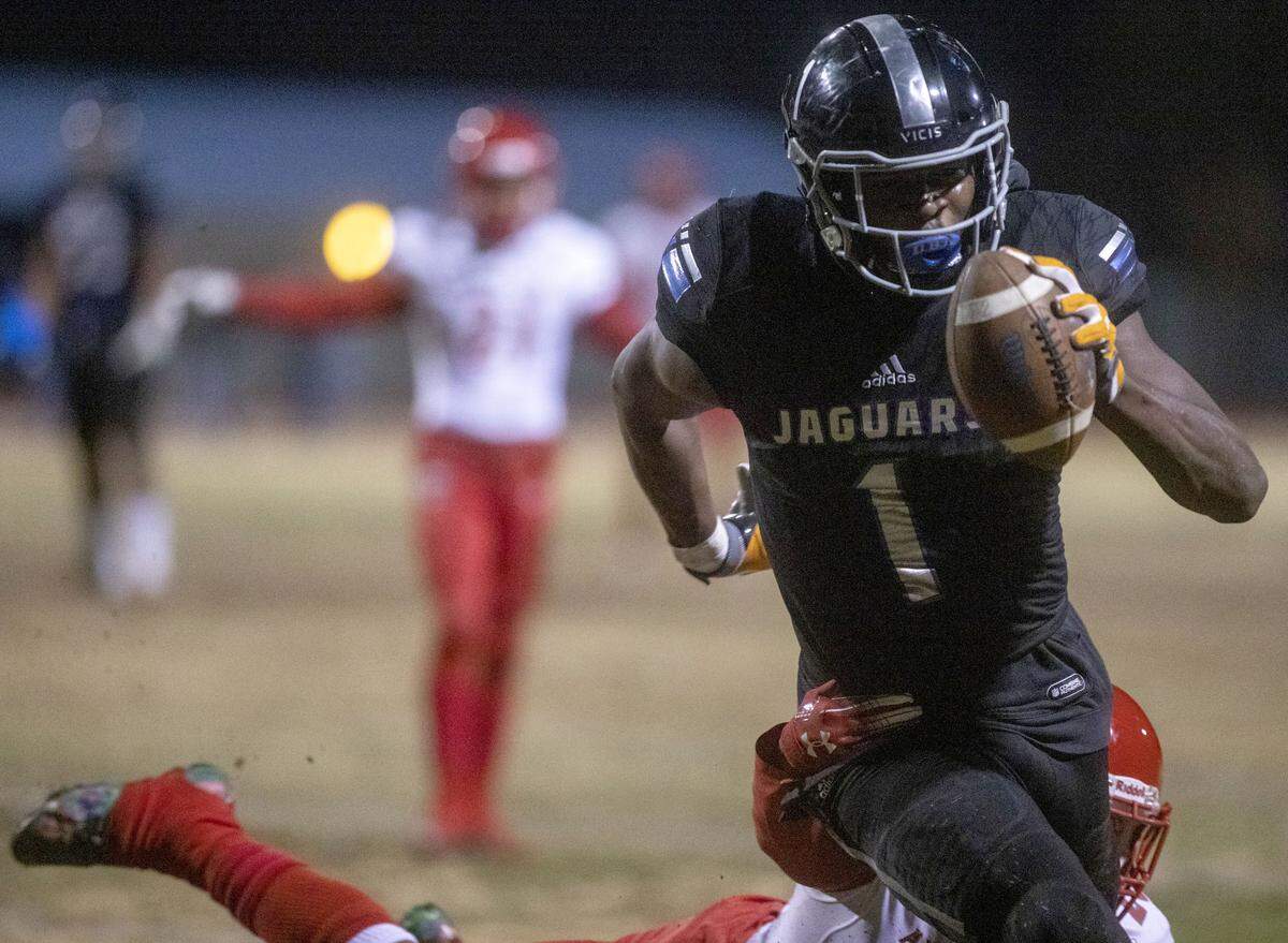 Desert Piness Darnell Washington (1) makes way to the end zone as Arbor View’s Rickie Davis Jr. (20) tackles him during the Mountain Region semifinals on Friday, Nov. 22, 2019, at Desert Pines High School in Las Vegas.