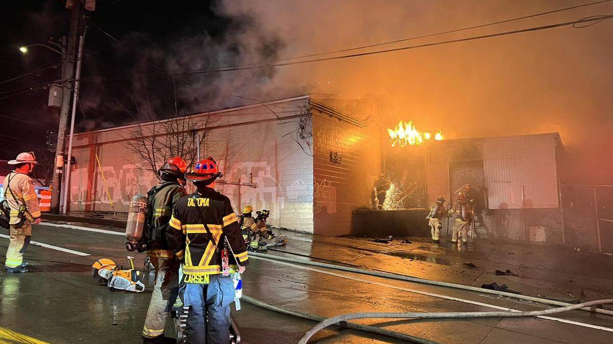 Tacoma Fire Department firefighters work the scene of a commercial building fire that broke out early Wednesday morning in a vacant building located at 323 E. 26th Street.
