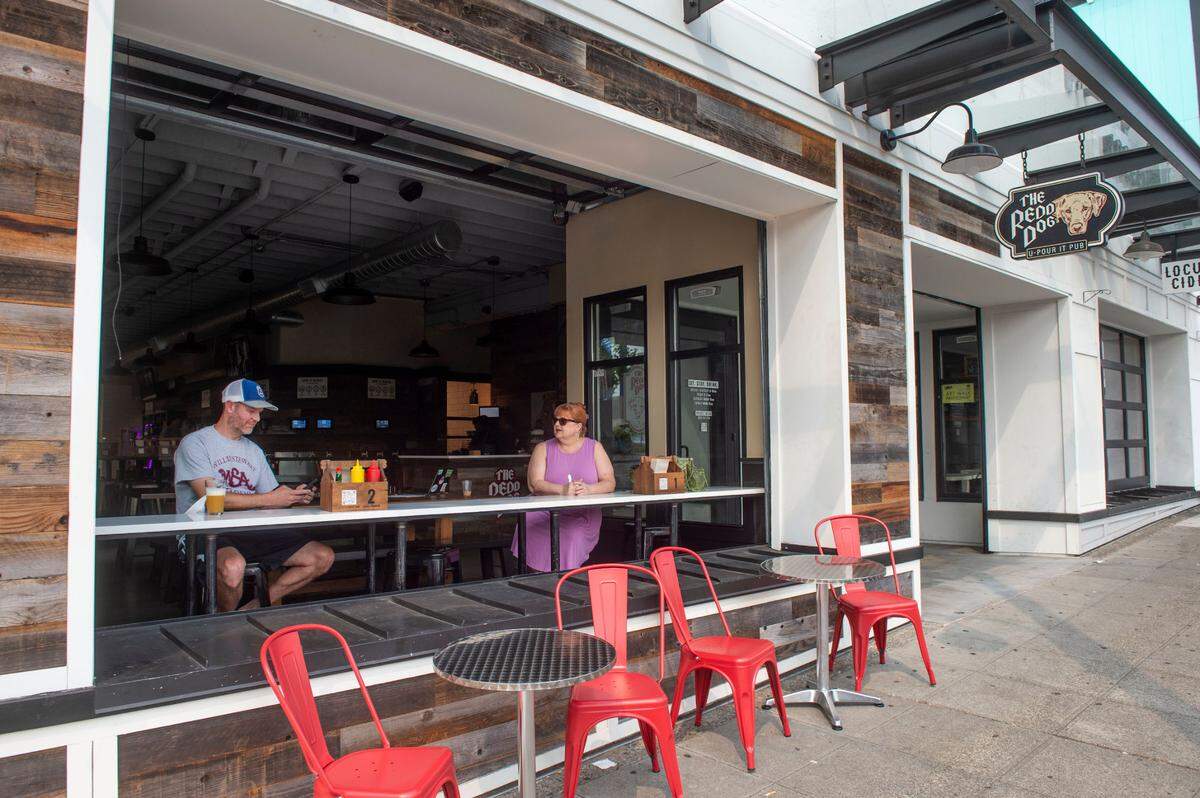 The Redd Dog features a roll-up garage door and big windows overlooking Tacoma’s Sixth Avenue. Look for artists in the side parking lot during Art on the Ave 2022.