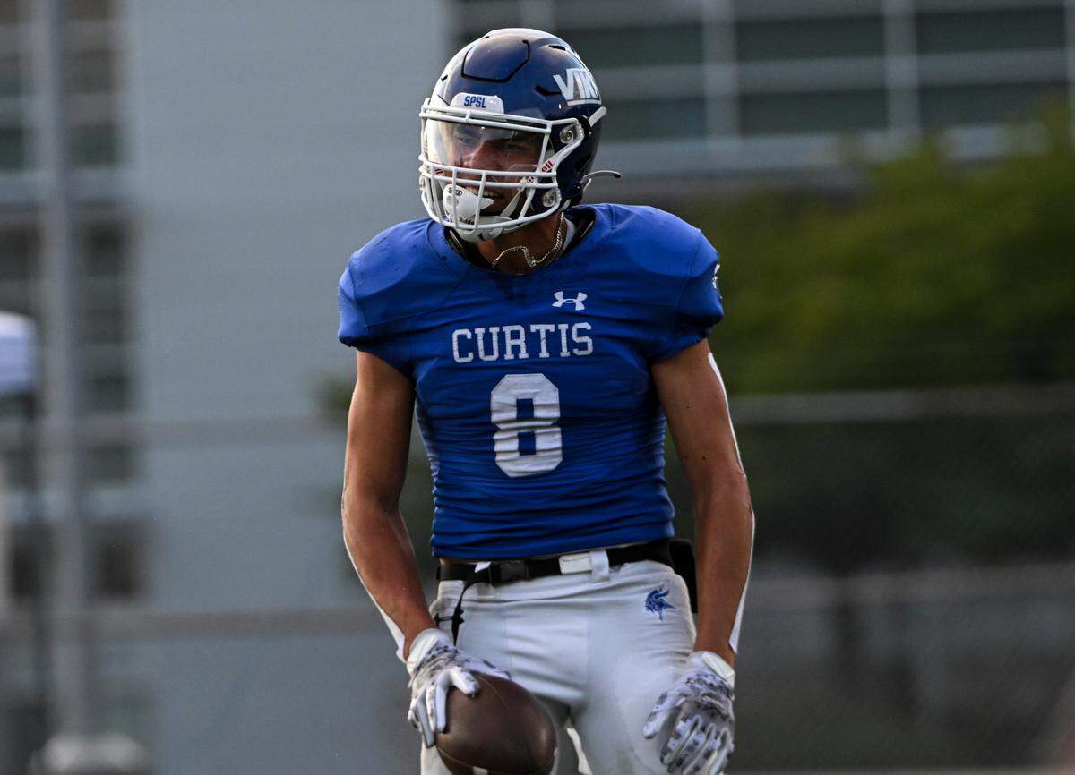 Curtis’s Xavier Ahrens (8) celebrates a touchdown against Olympia during the first half of the high school football game at Curtis Senior High School, Thursday, Aug. 31, 2023, University Place, Wash.