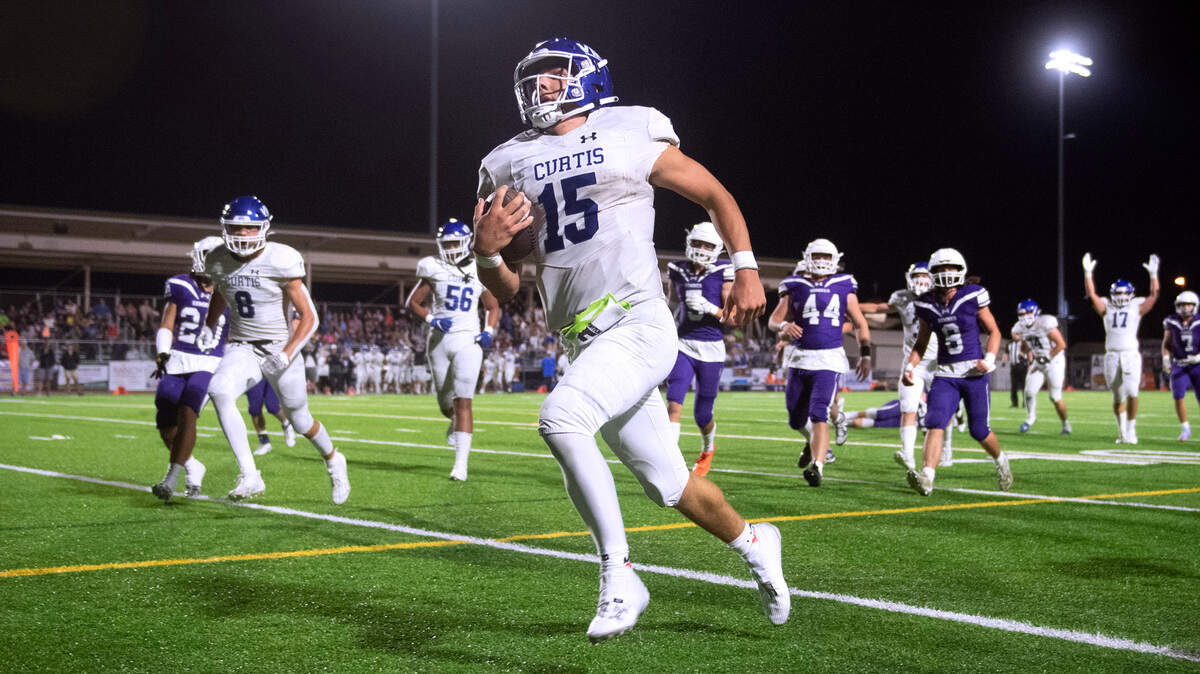 Curtis quarterback Rocco Koch sprints for a touchdown during Friday night’s football game against the Sumner Spartans at Sunset Chevy Stadium in Sumner, Washington, on Sept. 8, 2023. Curtis won the game, 38-33.