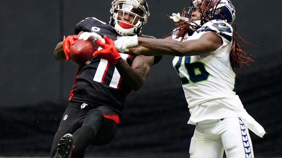 Atlanta Falcons wide receiver Julio Jones (11) makes the catch aganst Seattle Seahawks cornerback Shaquill Griffin (26) during the second half of an NFL football game, Sunday, Sept. 13, 2020, in Atlanta. (AP Photo/Brynn Anderson)