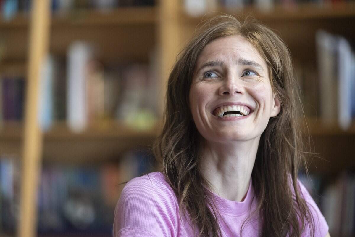 Amanda Knox turns to speak to her husband during an interview with The News Tribune about her upcoming one-woman show, “Cartwheel,” on Tuesday, July 7, 2026, at her home in Vashon, Wash.