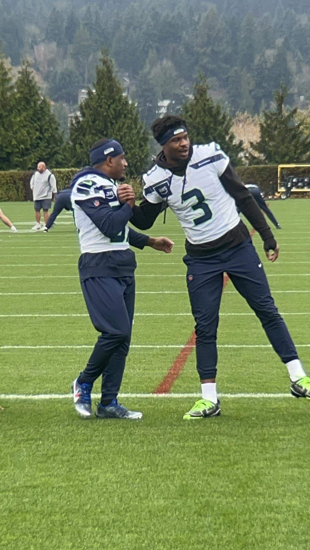 Quandre Diggs (37) and rookie safety Nick Emmanwori (3) greet each other at the start of Diggs’ return practice to the Seahawks Wednesday, Nov. 26, 2025, at the Virginia Mason Athletic Center in Renton. Injuries at safety promoted Seattle to sign back Diggs, their three-time Pro Bowl selection and team captain from 2019-23.