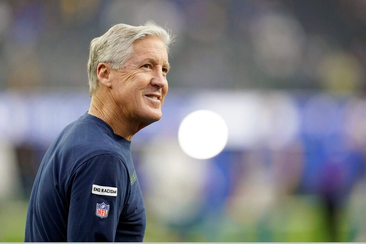 Seattle Seahawks head coach Pete Carroll walks on the field before an NFL football game against the Los Angeles Rams Tuesday, Dec. 21, 2021, in Inglewood, Calif. (AP Photo/Ashley Landis )
