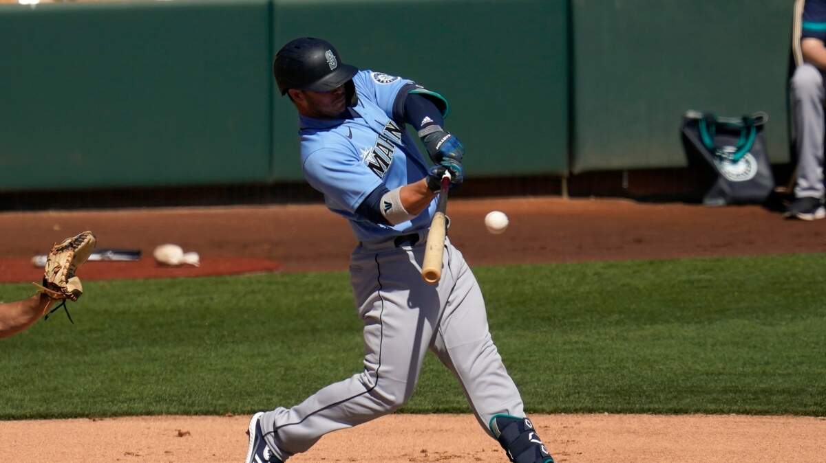 Seattle Mariners’ Ty France connects for a run-scoring single against the Chicago White Sox during the first inning of a spring training baseball game Friday, March 5, 2021, in Phoenix. (AP Photo/Ross D. Franklin)