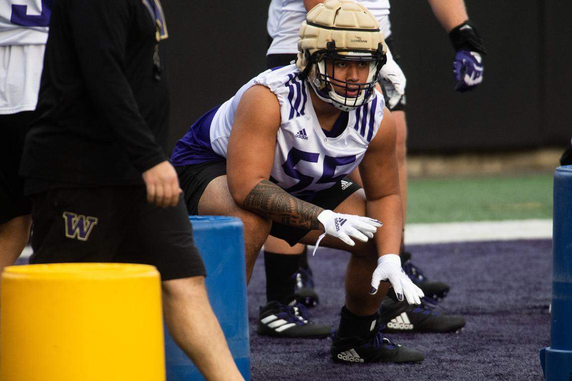 Troy Fautanu warms up during practice at Husky Stadium in Seattle, Wash., on Friday, Oct. 9, 2020.