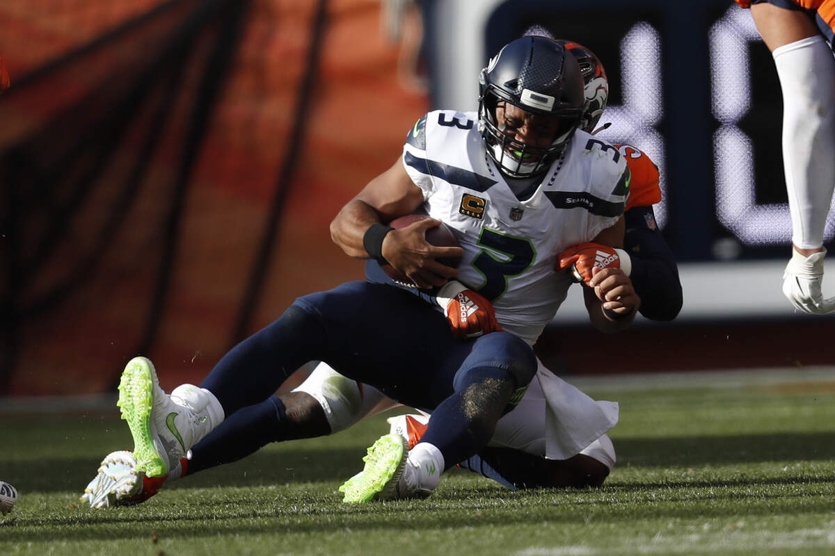 Broncos linebacker Von Miller sacks Seahawks quarterback Russell Wilson for one of the All-Pro linebacker’s three sacks during Seattle’s loss at Denver Sunday in the season opener.