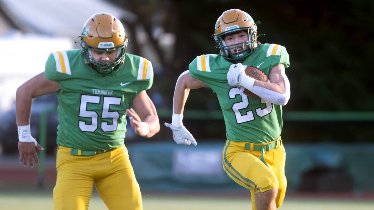 Tumwater running back Cash Short breaks loose alongside lineman Kade Contreras for a long touchdown run during Satuday afternoon’s state playoff game against the Sehome Mariners at Tumwater District Stadium in Tumwater, Washington, on Friday, Nov. 23, 2024. Tumwater won the game, 70-7, to advance to the state semifinals.
