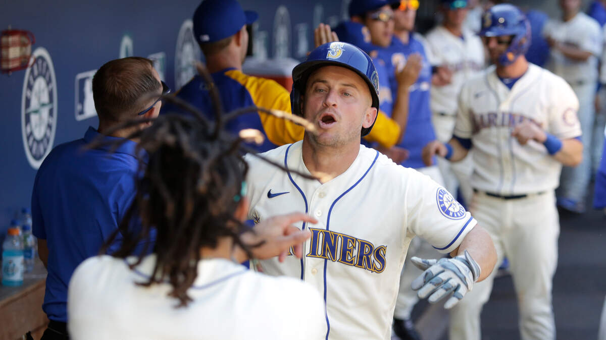 Seattle Mariners’ Kyle Seager, center, celebrates with J.P. Crawford (3) after hitting a two-run home run during the seventh inning of a baseball game against the Kansas City Royals, Sunday, Aug. 29, 2021, in Seattle. (AP Photo/Jason Redmond)