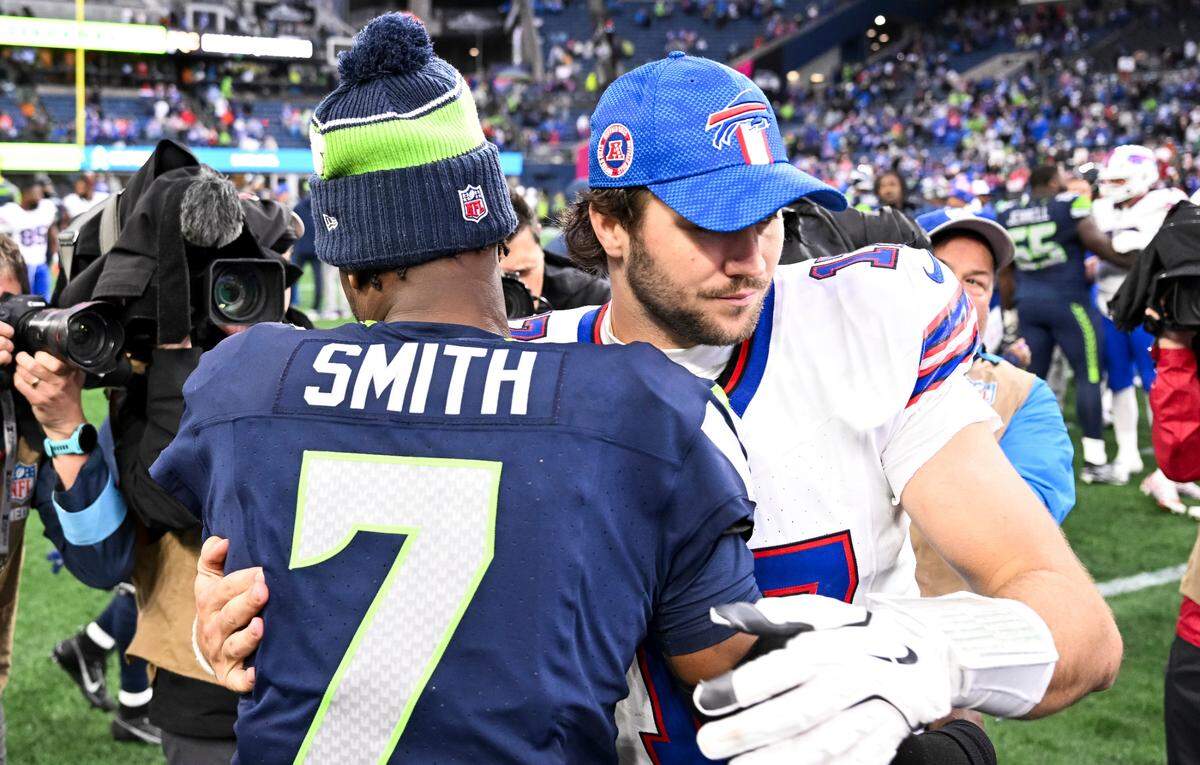 Seattle Seahawks quarterback Geno Smith (7) and Buffalo Bills quarterback Josh Allen (17) hug after the Buffalo Bills 31-10 victory against the Seattle Seahawks at Lumen Field, on Sunday, Oct. 27, 2024 in Seattle, Wash.