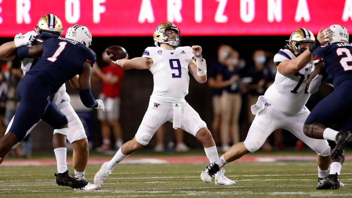 Washington quarterback Dylan Morris (9) throws a pass during the first half of the team’s NCAA college football game against Arizona on Friday, Oct. 22, 2021, in Tucson, Ariz. (AP Photo/Chris Coduto)