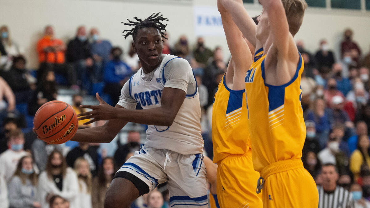 Curtis’s guard Zoom Diallo (5) passes the ball as Tahoma’s forward Carson Talbert (30) and Tahoma’s forward Adam Davis (14) defends during the 4A District 3/4 high school boys basketball championship game at the Curtis High School on Saturday, Feb. 19, 2022, in University Place, Wash.
