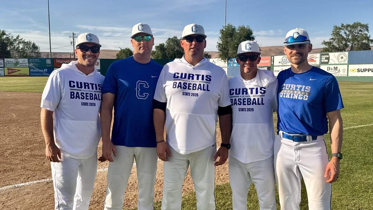 Nate Angelo, second from right, is taking over as the new head coach of the Curtis High School varsity baseball program, replacing Bryan Robinson (middle), who stepped down after the 2026 season to spend more time with family.