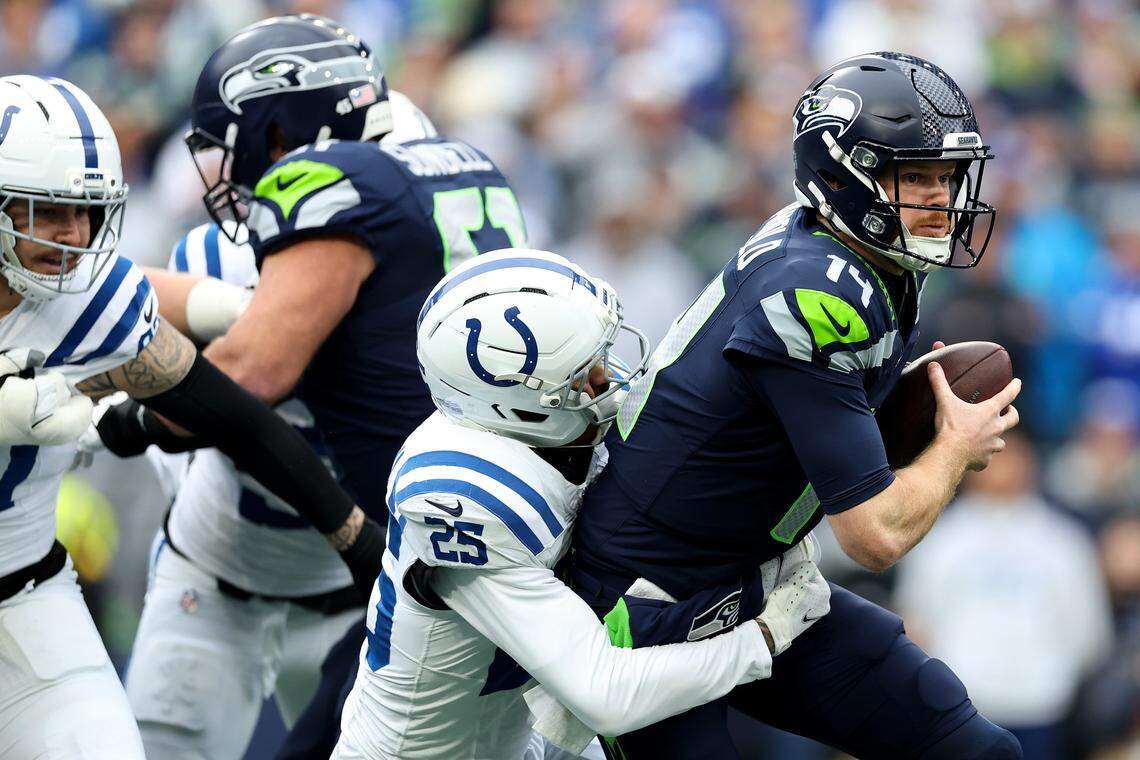 SEATTLE, WASHINGTON - DECEMBER 14: Rodney Thomas II #25 of the Indianapolis Colts brings down Sam Darnold #14 of the Seattle Seahawks at Lumen Field on December 14, 2025 in Seattle, Washington. (Photo by Steph Chambers/Getty Images)