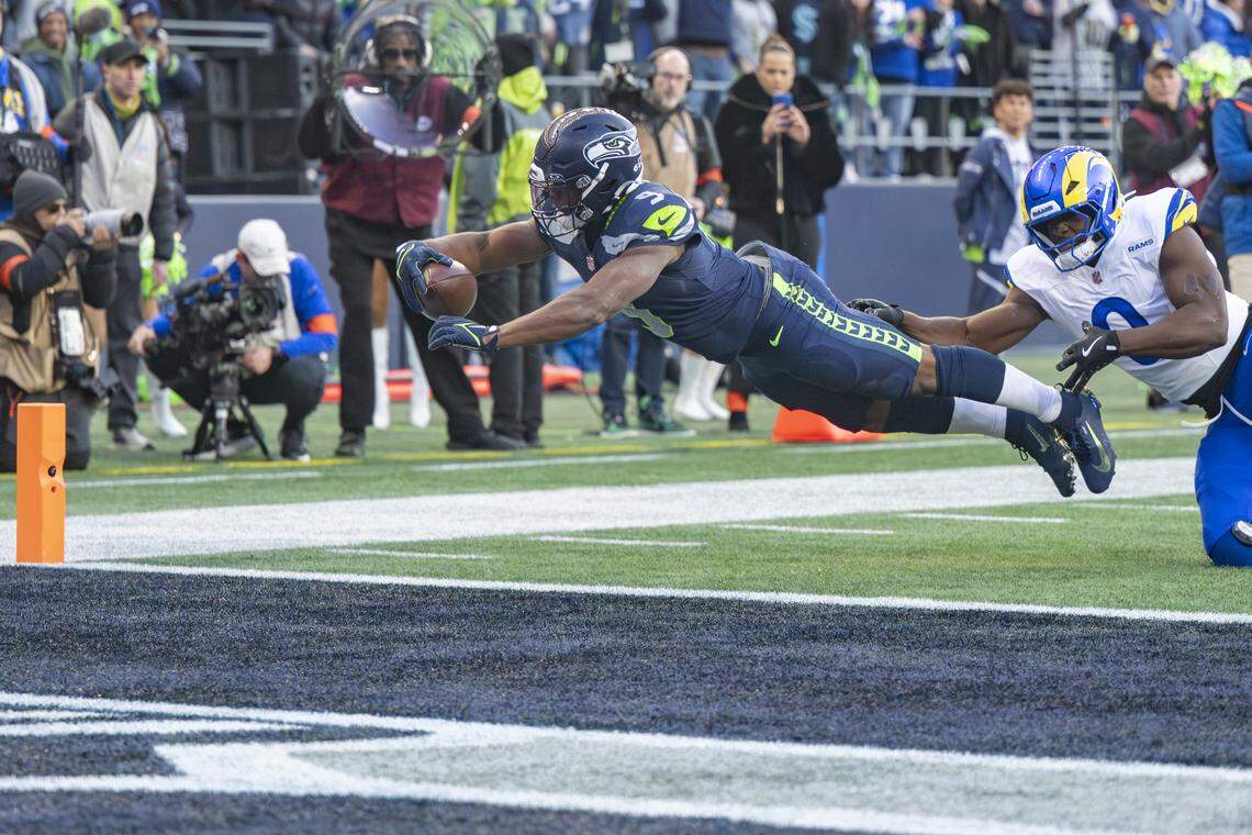 Seattle Seahawks running back Kenneth Walker III (9) dives into the end zone for touchdown against the Rams during the NFC Championship game at Lumen Field, on Sunday, Jan. 25, 2026, in Seattle.
