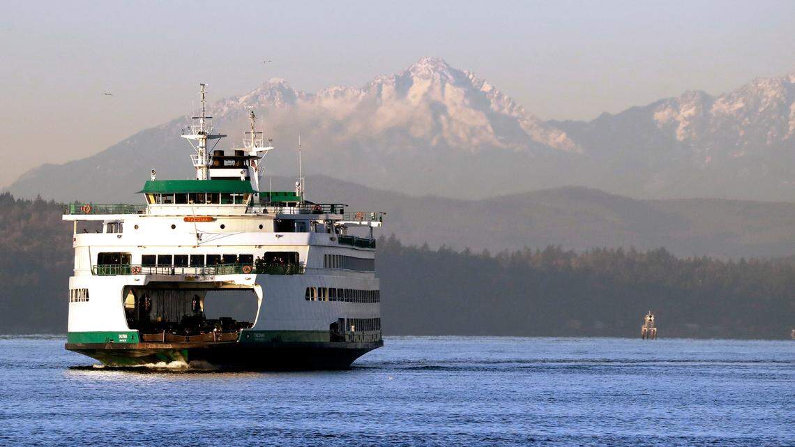 The Washington state ferry Tacoma crosses the Puget Sound in view of the Olympic mountains behind Thursday morning, Dec. 6, 2018, in Seattle. After several days of sunny skies and overnight temperatures below freezing, clouds are expected to return over the next few days with slightly warmer temperatures with rain likely by Sunday. (AP Photo/Elaine Thompson)
