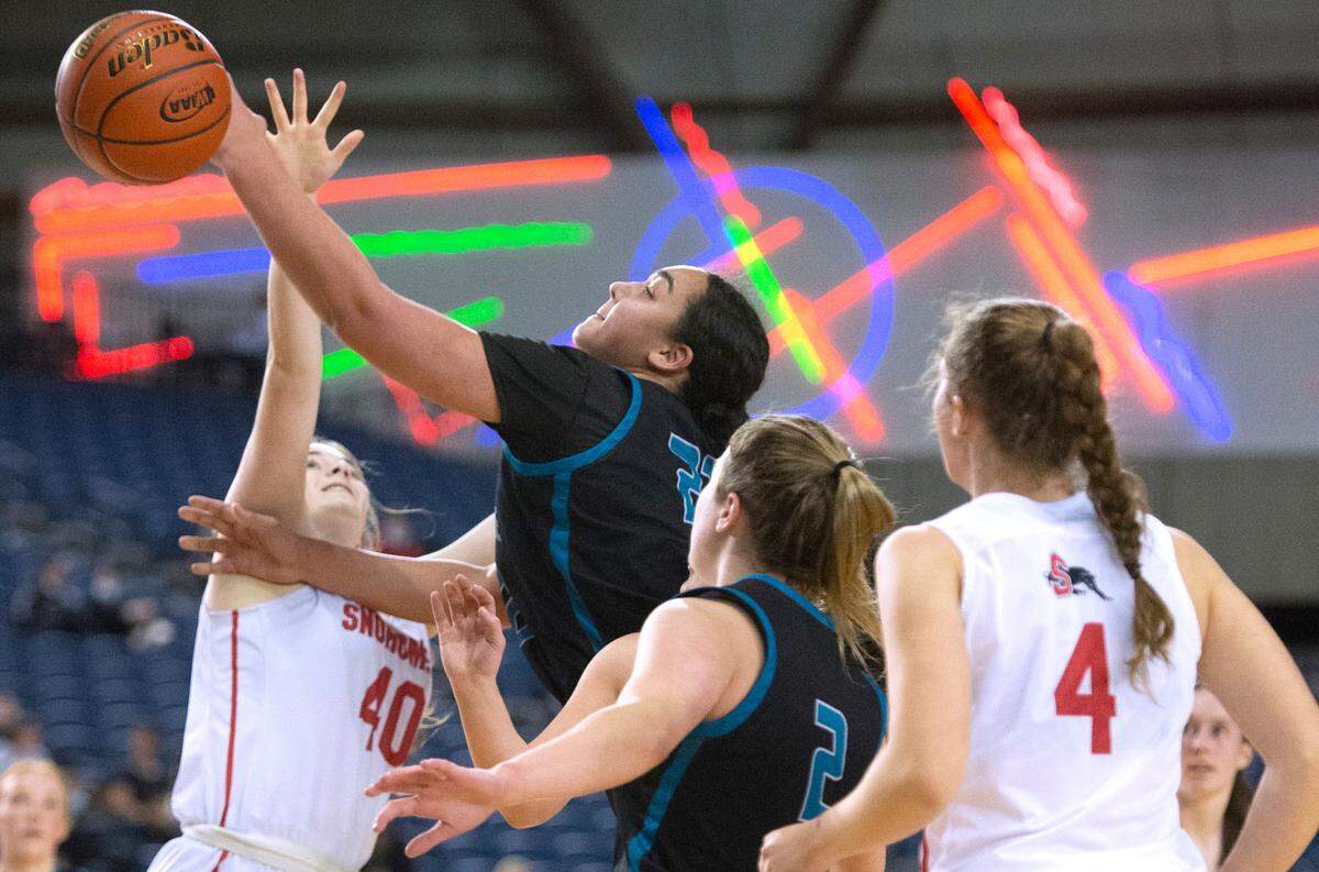 Bonney Lake’s Jazmyn Shipp puts up a shot over Snohomish defenders Paige Hampton (40) and Brianna Ulrich during Wednesday evening’s opening-round game of the WIAA 3A Girls Basketball State Championships tournament in the Tacoma Dome in Tacoma, Washington, on Wednesday, March 2, 2022.