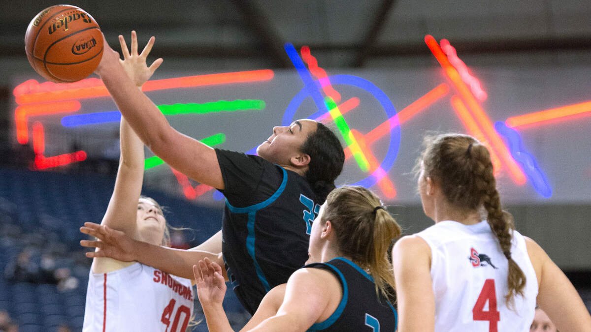 Bonney Lake’s Jazmyn Shipp puts up a shot over Snohomish defenders Paige Hampton (40) and Brianna Ulrich during Wednesday evening’s opening-round game of the WIAA 3A Girls Basketball State Championships tournament in the Tacoma Dome in Tacoma, Washington, on Wednesday, March 2, 2022.