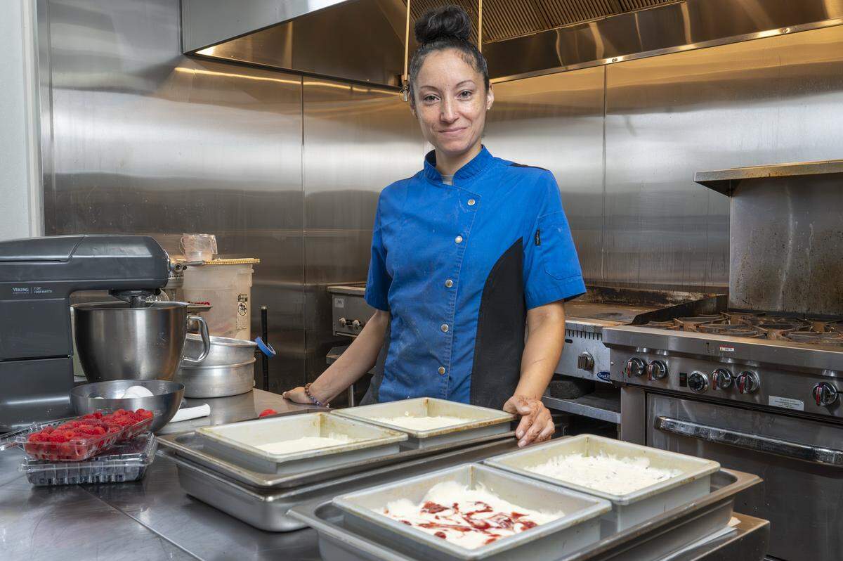 Lydia Mendez, owner of Little Miss Sweets NYC, stands next to pans of prepared New York-style cheesecakes for a photo on Wednesday, Aug. 6, 2025, in Tacoma, Wash.