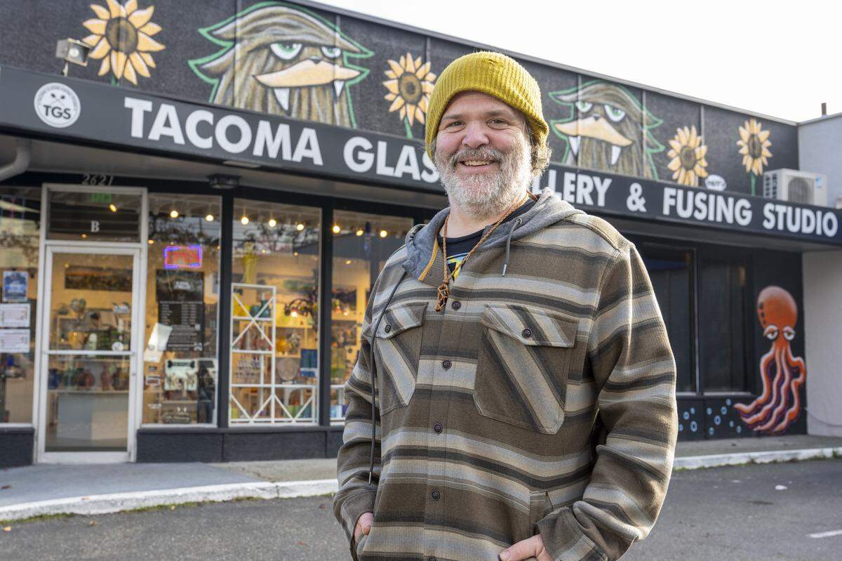 Muralist Ryan “Henry” Ward stands in front of one of his Sasquatch murals on Wednesday, Nov. 19, 2025, in Tacoma, Wash.