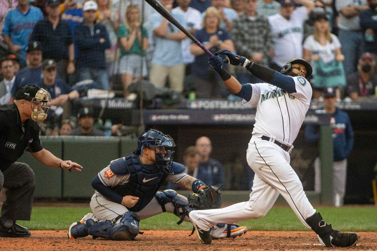 Seattle Mariners first baseman Carlos Santana (41) swings at a pitch by Houston Astros relief pitcher Ryan Pressly (55) during the bottom of the ninth inning of game 3 of the ALDS on Saturday, Oct. 15, 2022, at T-Mobile Park in Seattle. He ended up striking out for the second out of the inning.