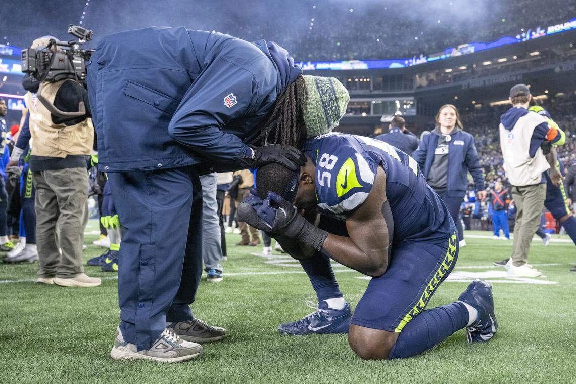 Seattle Seahawks linebacker Derick Hall (58) kneels on the ground after the Seahawks’ win over the Rams for the NFC Championship at Lumen Field, on Sunday, Jan. 25, 2026, in Seattle.