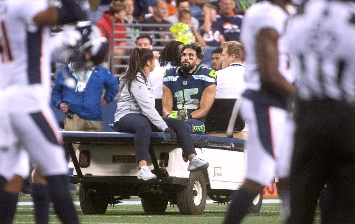 Seahawks wide receiver John Ursua is taken off the field on a cart after getting injured during Saturday night’s NFL preseason football game against the Denver Broncos at Lumen Field in Seattle, Washington, on Saturday, Aug. 21, 2021.