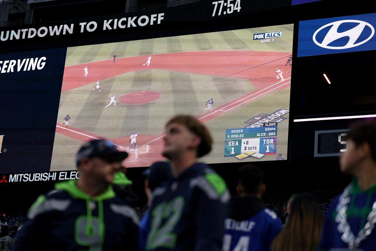 SEATTLE, WASHINGTON - OCTOBER 20: Seattle Seahawks fans watch Game Seven of the American League Championship Series between the Toronto Blue Jays and the Seattle Mariners before the game against the Houston Texans at Lumen Field on October 20, 2025 in Seattle, Washington. (Photo by Steph Chambers/Getty Images)