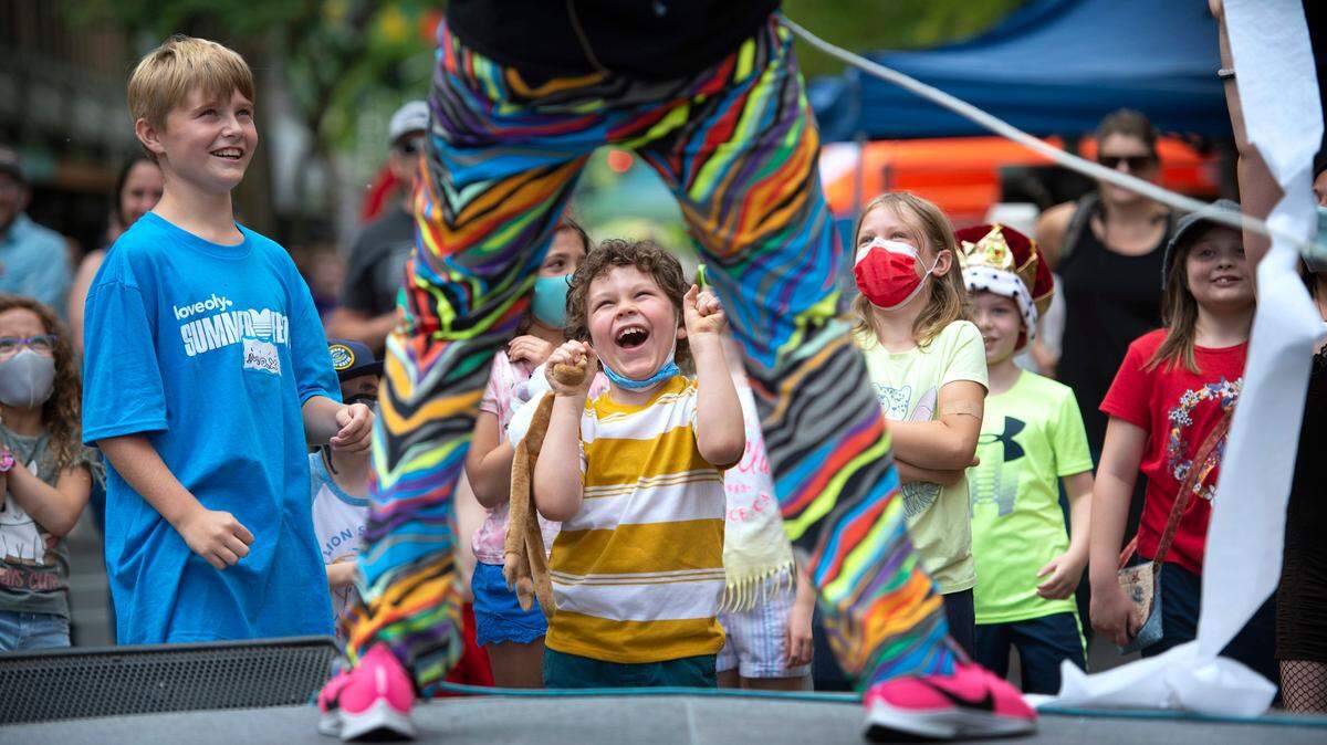 Liam Laurie, 7, of Ferndale, cheers along to comedy juggler Alex Zerbe of Olympia on the Fifth Avenue performance stage during the inaugural 2021 LoveOly SummerFest in downtown Olympia.