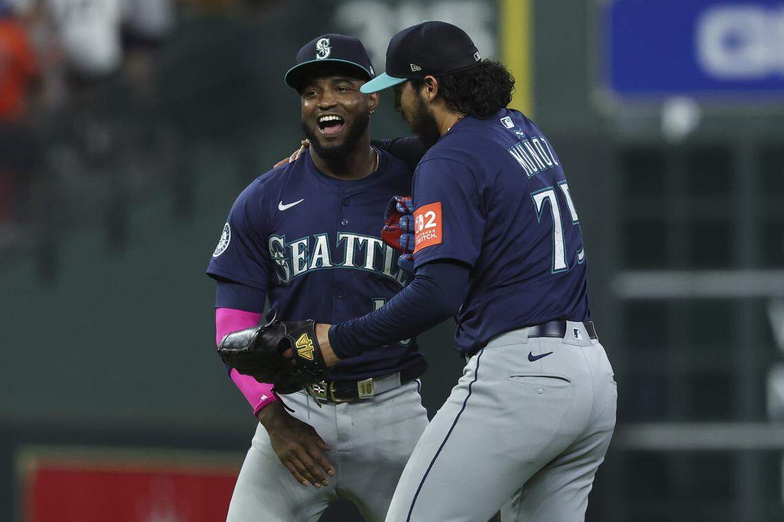 Sep 20, 2025; Houston, Texas, USA; Seattle Mariners right fielder Victor Robles (10) celebrates with relief pitcher Andres Munoz (75) after the game against the Houston Astros at Daikin Park. Mandatory Credit: Troy Taormina-Imagn Images