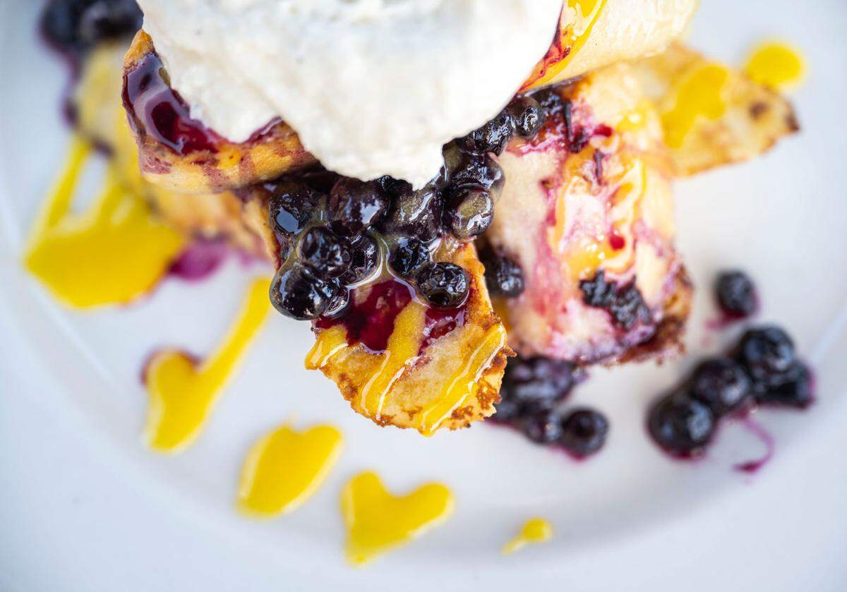 Since opening in 2013, Netshed’s most popular dish is this decadent French toast with seasonal fruit, dolloped with whipped ricotta. In May 2023, it featured fresh blueberries and tangy lemon curd.