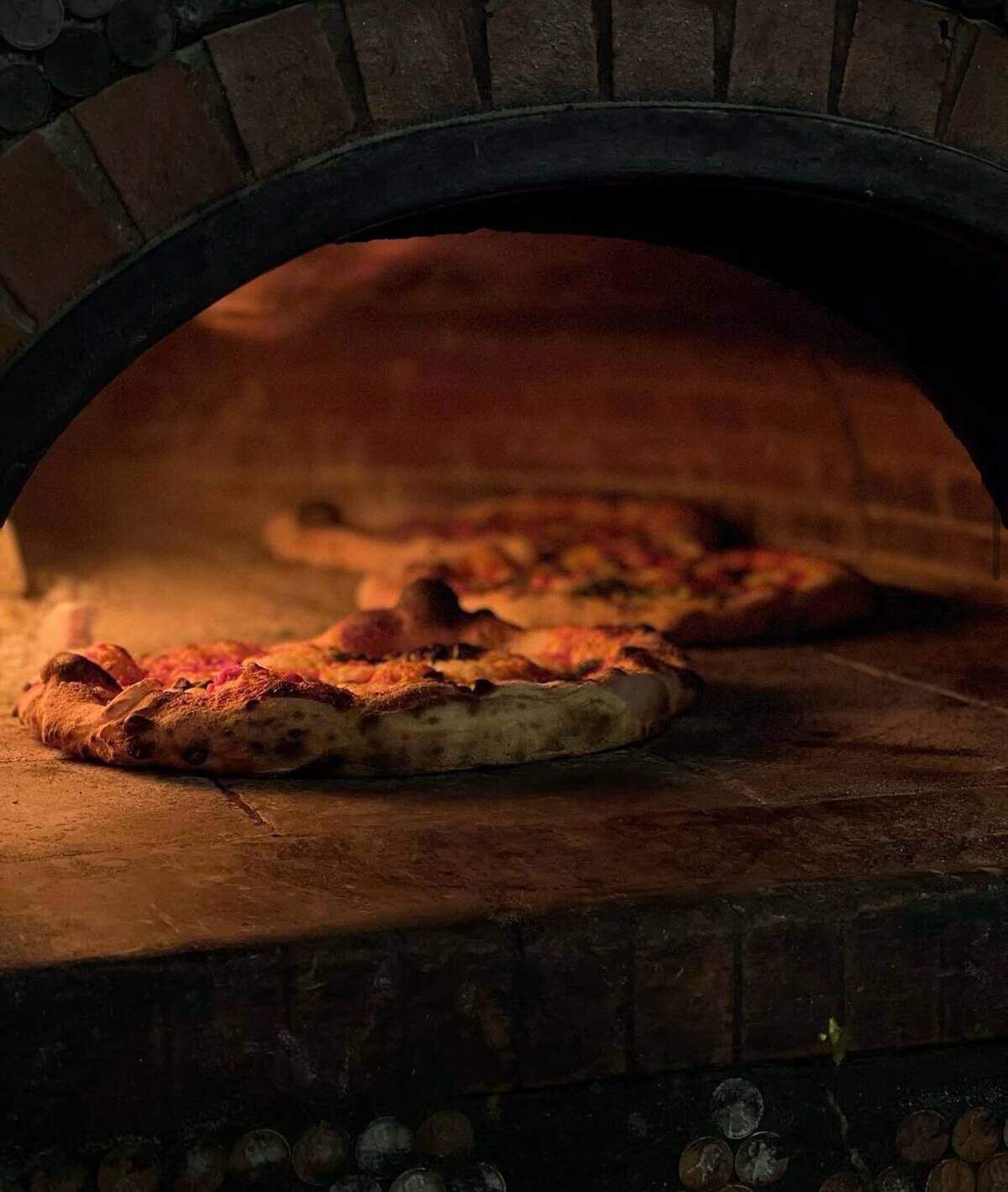 A pizza bakes in the oven at Carlson Block, a pizzeria in Wilkeson. The restaurant is one of the businesses in Wilkeson that gets a boost each summer from tourists headed to Mount Rainier National Park. Now, with the Carbon River Fairfax Bridge closed, local businesses are looking for more creative ways to draw the public to their town.