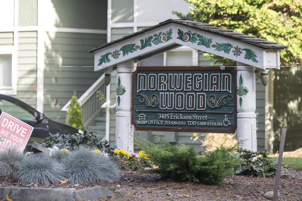 A sign marks the entrance to apartment complex Norwegian Wood on Tuesday, Nov. 11, 2025, in Gig Harbor, Wash.