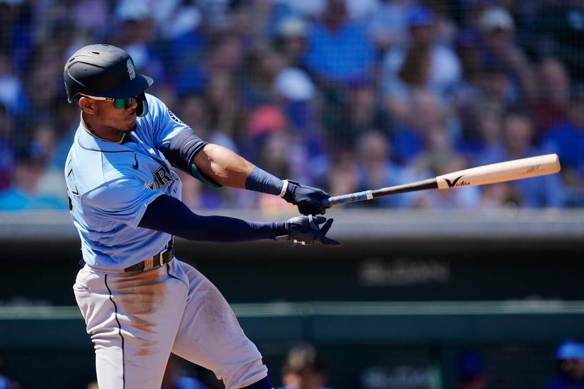 Seattle Mariners’ Julio Rodriguez swings at a pitch against the Chicago Cubs during the third inning of a spring training baseball game Wednesday, March 30, 2022, in Mesa, Ariz. (AP Photo/Ross D. Franklin)