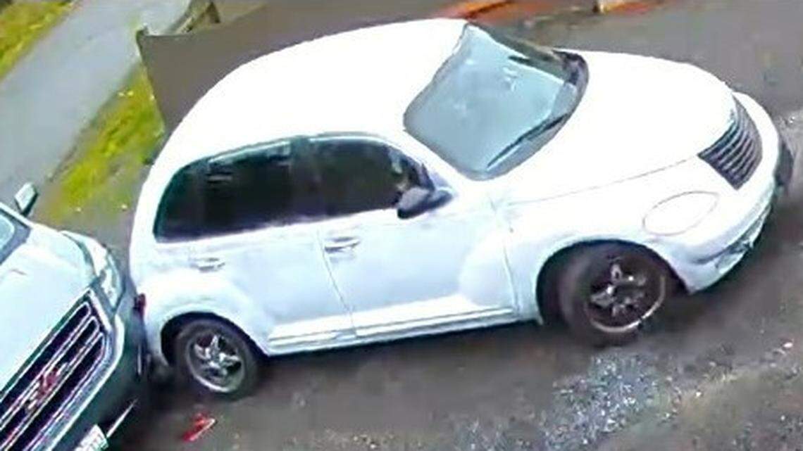 In this photo, a spray painted white PT Cruiser is shown at a Marysville, Washington, home on Oct. 23, 2021. The victim caught burglary suspects on their home surveillance camera so they returned home and parked behind the car, police said.