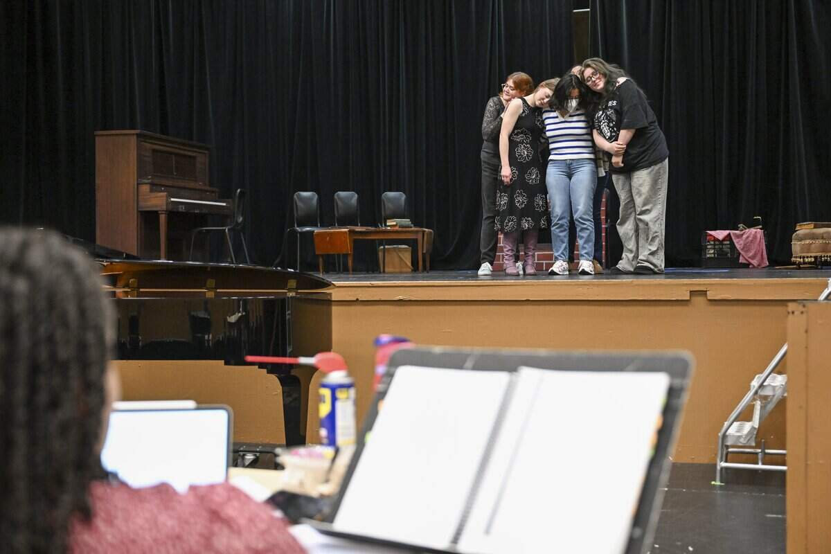 The March family leans in for a hug during a rehearsal of musical Little Women on Wednesday, June 3, 2026, at Tacoma Community College in Tacoma, Wash. The musical is the first fully-staged production at TCC in more than 30 years.