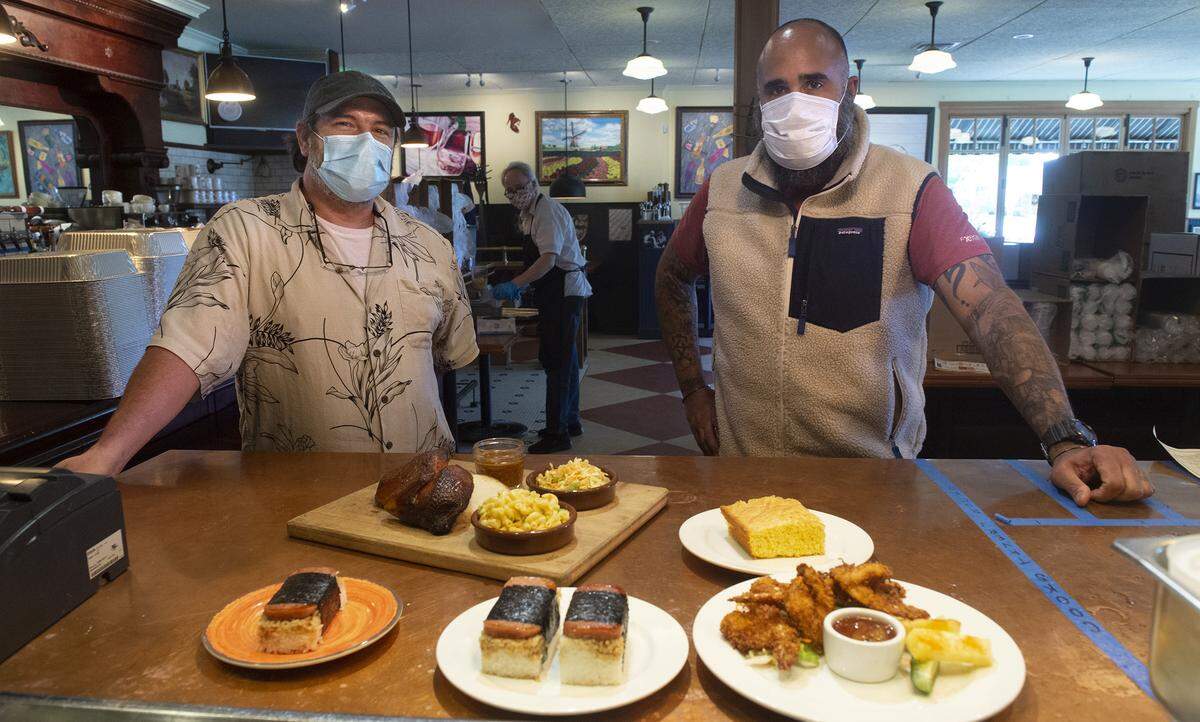 General manager Rich Gantner (left) and executive chef Anthony Hubbard at their Cooks Tavern in north end Tacoma on Tuesday, June 2, 2020. The comfort-food restaurant has added two walk-up specialty food windows - Popoki Nani Hawaiian food and G&H Pig Palace barbecue.