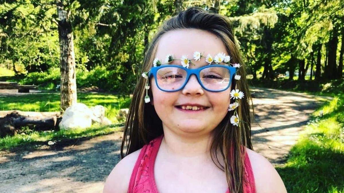 Annie Chisholm, 6, who is going into first grade, has learned to make daisy chains.