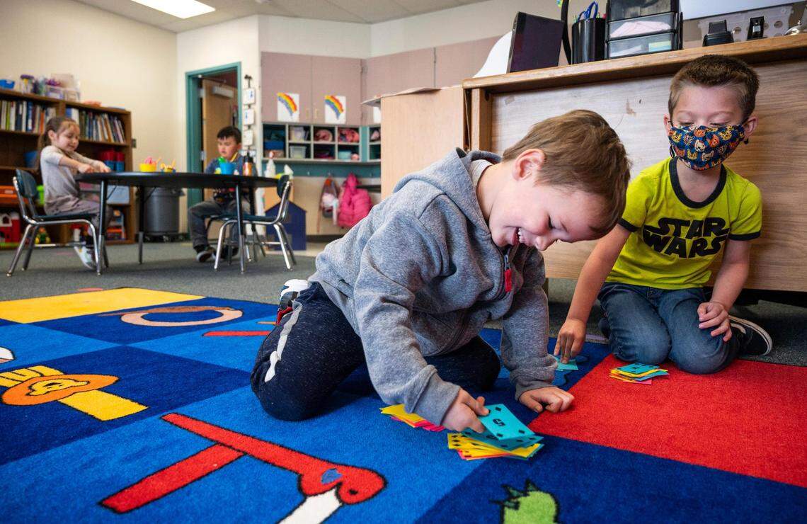 Parker Stanton, left, plays a math game with Javier Holguin, right, during a transitional kindergarten class activity at Harbor Heights Elementary School on Thursday, April 28, 2022 in Wollochet, Wash. The Peninsula School District has a new six-month transitional kindergarten program to get kids prepared for kindergarten.