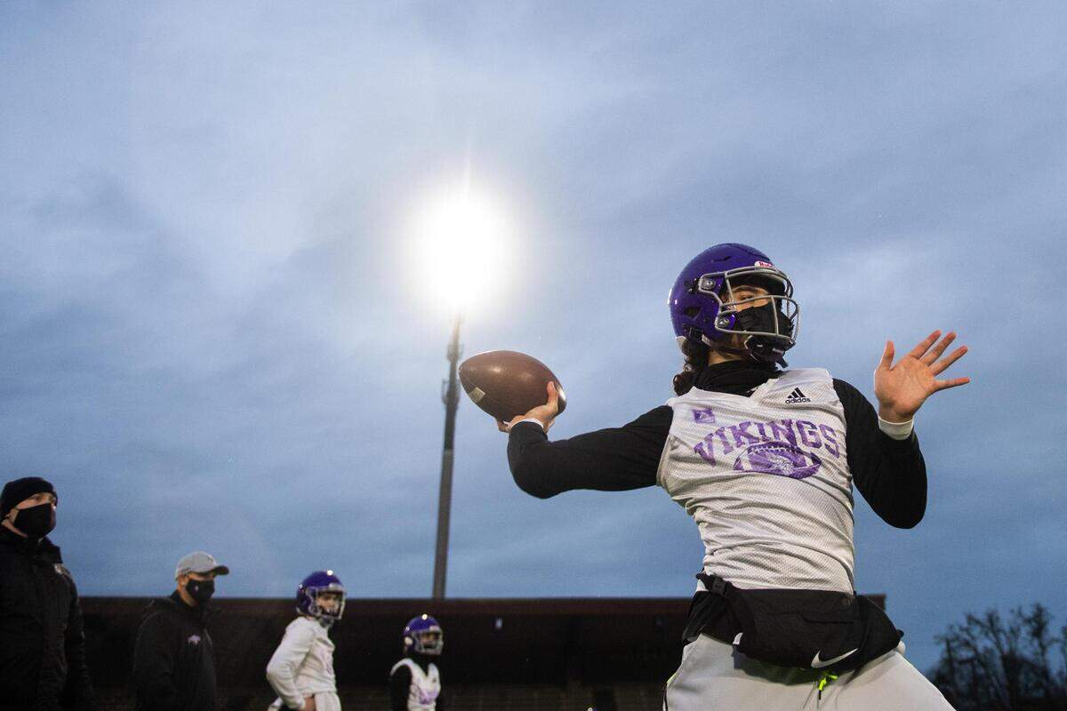 Quarterback Luke Holcomb throws a pass during drills. The Puyallup Vikings held their first football practice at Sparks Stadium in Puyallup, Wash., on Monday, Feb. 1, 2021.
