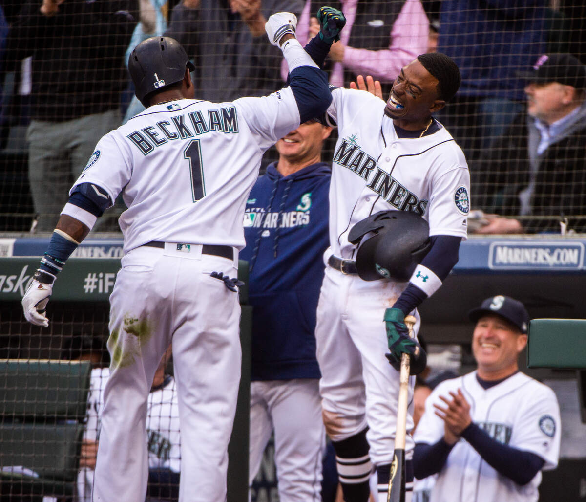 Mariners’ Dee Gordon celebrates with Tim Beckham (1) after Beckham’s second home run in the game. The Seattle Mariners played the Boston Red Sox in a Major League Baseball game at T-Mobile Park in Seattle, Wash., on Thursday, March 28, 2019.