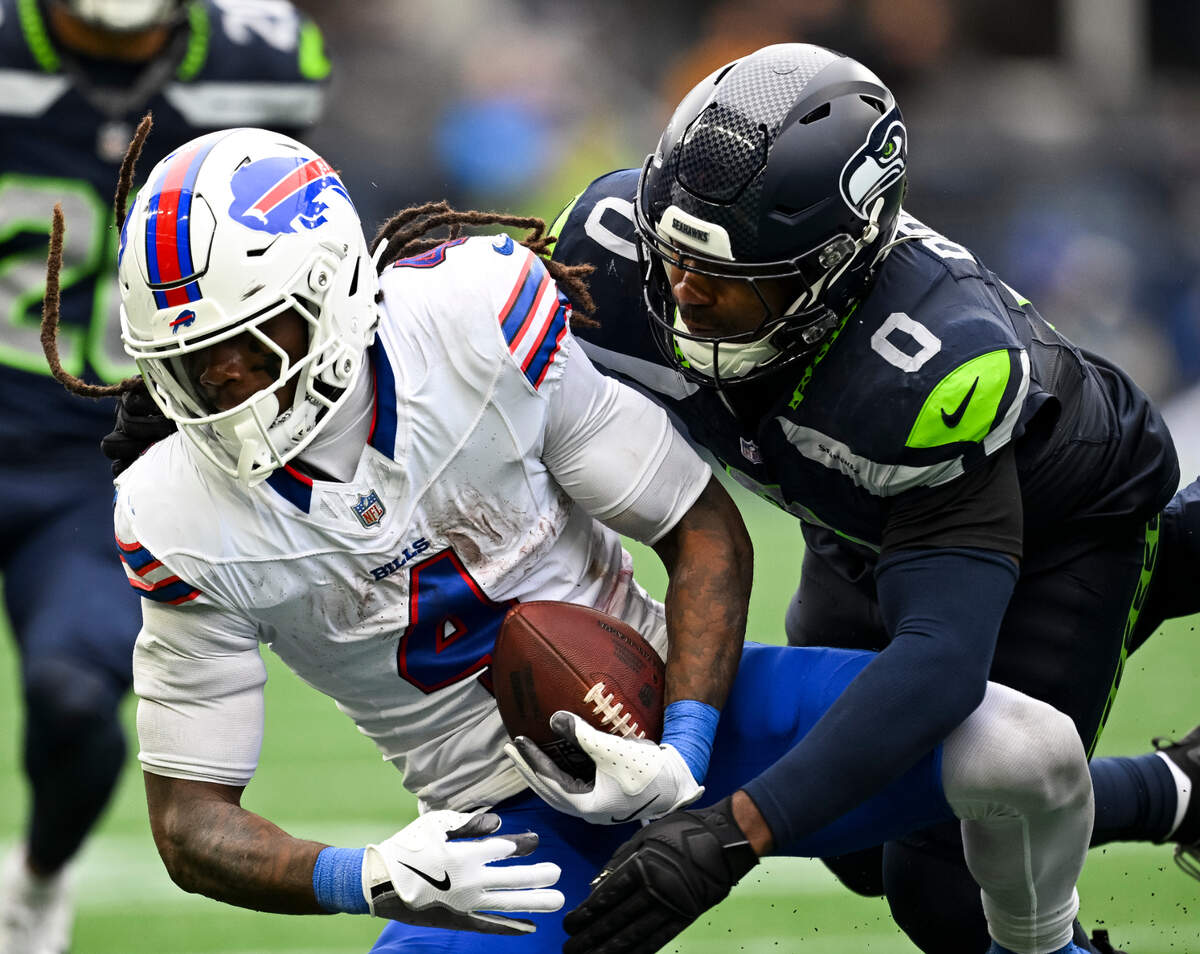 Buffalo Bills running back James Cook (4) is tackled by Seattle Seahawks linebacker Tyrel Dodson (0) during the fourth quarter of the game at Lumen Field, on Sunday, Oct. 27, 2024 in Seattle, Wash.
