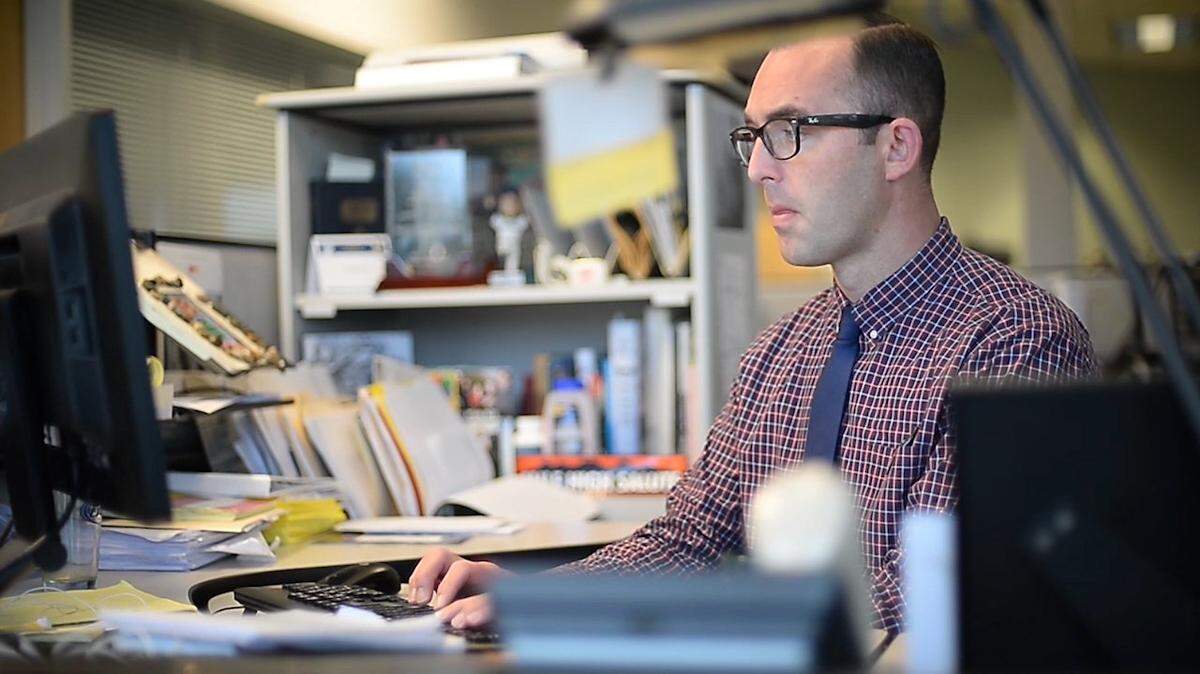 The News Tribune columnist Matt Driscoll works at his desk.